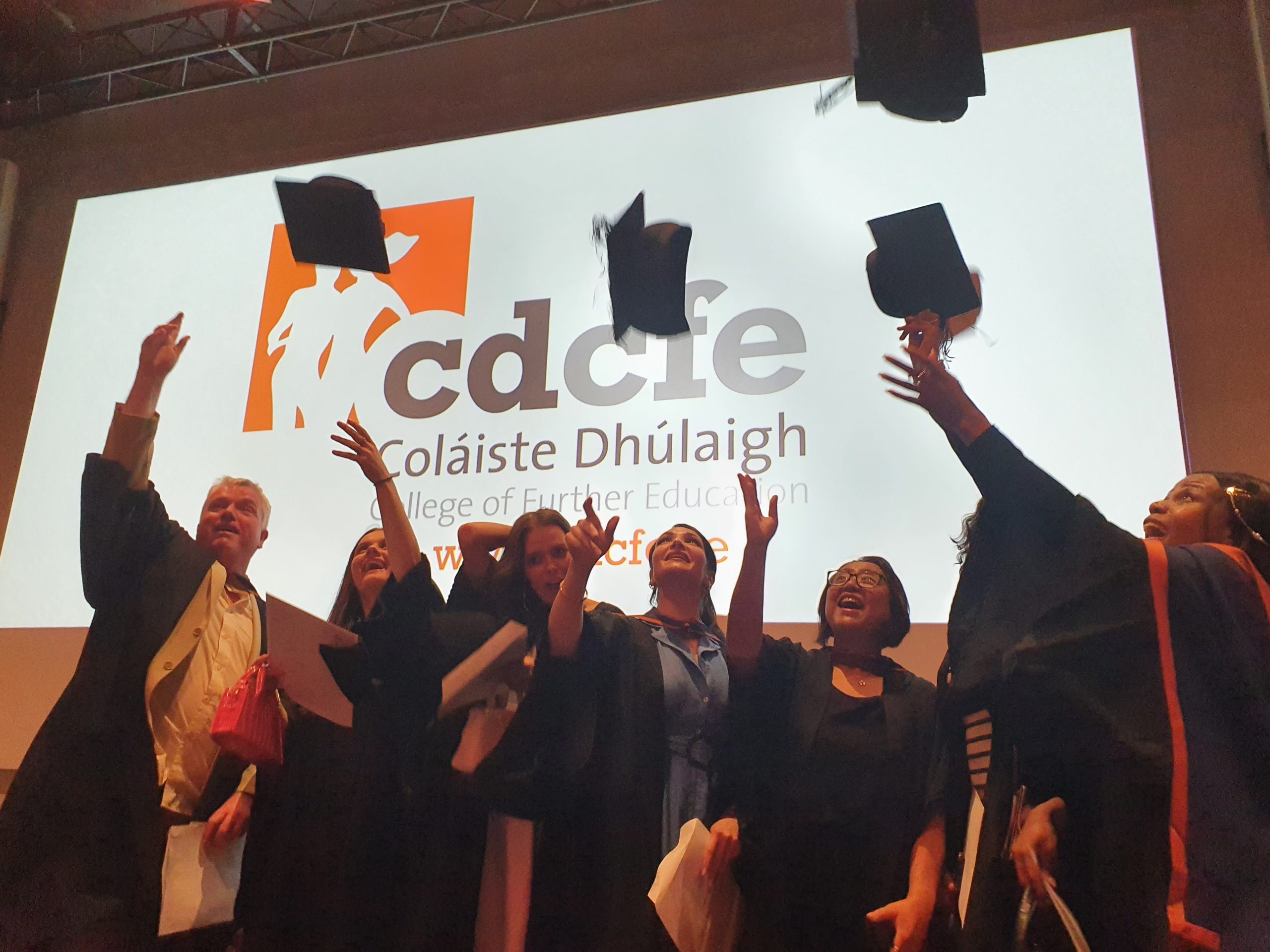 Graduates toss their caps at CDCFE ceremony